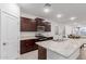 Modern kitchen featuring dark wood cabinets, granite countertops, and an open layout at 21105 N Blue Agave Dr, Maricopa, AZ 85138