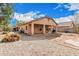 The backyard features potential planting areas, a view of the home's exterior, and a stone yard at 21752 E Domingo Rd, Queen Creek, AZ 85142