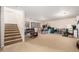 Large basement area offering ample space with carpet flooring, staircase, and potential for customizable use at 21752 E Domingo Rd, Queen Creek, AZ 85142