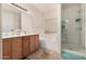 Bathroom featuring a shower, tub, dual sink vanity and tiled floor at 21752 E Domingo Rd, Queen Creek, AZ 85142