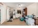 A cozy room that includes cabinets, shelving units and a sewing machine on the left, with a light tan carpet at 21752 E Domingo Rd, Queen Creek, AZ 85142