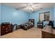 Blue bedroom with ceiling fan, desk and window at 21752 E Domingo Rd, Queen Creek, AZ 85142