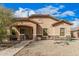 Charming single-story home with a well-maintained landscape, stone accents, and covered porch at 21752 E Domingo Rd, Queen Creek, AZ 85142
