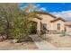 Charming single-story home with a well-maintained landscape, stone accents, and covered porch at 21752 E Domingo Rd, Queen Creek, AZ 85142