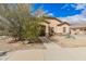Charming single-story home with a well-maintained landscape, stone accents, and covered porch at 21752 E Domingo Rd, Queen Creek, AZ 85142