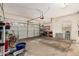 A spacious three car garage with ample storage options with a bicycle on the side at 21752 E Domingo Rd, Queen Creek, AZ 85142