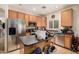 Well-lit kitchen features stainless steel appliances, wooden cabinets, and a functional island with a black countertop at 21752 E Domingo Rd, Queen Creek, AZ 85142
