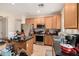 Spacious kitchen showcases wooden cabinetry, stainless steel appliances, and a convenient island with ample countertop space at 21752 E Domingo Rd, Queen Creek, AZ 85142