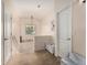 Cozy landing area with neutral tones, offering access to different rooms, lit by a decorative light fixture at 21752 E Domingo Rd, Queen Creek, AZ 85142