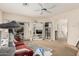 Neutral living room featuring a ceiling fan, carpeted floors, and access to the backyard at 21752 E Domingo Rd, Queen Creek, AZ 85142
