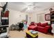 Living room with carpet, ceiling fan, desk and sofa at 21752 E Domingo Rd, Queen Creek, AZ 85142