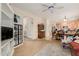 Bright living room featuring a ceiling fan, display cabinet, and open layout leading to the kitchen and other areas at 21752 E Domingo Rd, Queen Creek, AZ 85142
