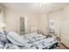 Bright bedroom with a ceiling fan, plush bedding, ensuite bathroom, and a closet for storage at 21752 E Domingo Rd, Queen Creek, AZ 85142