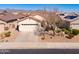Aerial shot of a home featuring a two-car garage, desert landscaping, and tiled roof at 22520 W Moonlight Path, Buckeye, AZ 85326