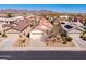Expansive aerial view of the community showcasing mountain views, solar panels and desert landscaping at 22520 W Moonlight Path, Buckeye, AZ 85326