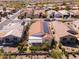 An aerial view of a neighborhood with desert landscaping and homes featuring solar panels on some roofs at 22520 W Moonlight Path, Buckeye, AZ 85326