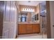 Well-lit bathroom with double vanity and glass shower at 22520 W Moonlight Path, Buckeye, AZ 85326