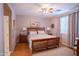 Comfortable bedroom with a wooden bed frame, bedside tables, and a ceiling fan at 22520 W Moonlight Path, Buckeye, AZ 85326