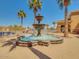 A beautiful tiered fountain with a blue pool and lounge seating in the Sundance community at 22520 W Moonlight Path, Buckeye, AZ 85326