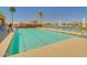 A community pool with lounge chairs and umbrellas creating a relaxing and inviting atmosphere at 22520 W Moonlight Path, Buckeye, AZ 85326