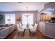 Open concept dining area with hardwood floors and views into the kitchen and living spaces at 22520 W Moonlight Path, Buckeye, AZ 85326