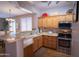 Well-maintained kitchen featuring stainless steel appliances and warm wood cabinetry at 22520 W Moonlight Path, Buckeye, AZ 85326