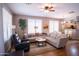 Bright and open living space featuring hardwood floors, a ceiling fan, and comfortable seating at 22520 W Moonlight Path, Buckeye, AZ 85326