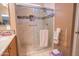 Elegant shower with glass door and tiled walls at 22520 W Moonlight Path, Buckeye, AZ 85326