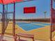 A tennis court surrounded by a chain-link fence and a bench to rest at 22520 W Moonlight Path, Buckeye, AZ 85326