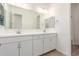 Bathroom featuring double vanity, quartz countertop, and white cabinets at 24134 N 172Nd Ave, Surprise, AZ 85387