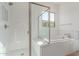 Shower and soaking tub combination features subway tile, mosaic tile floor, and glass door at 24134 N 172Nd Ave, Surprise, AZ 85387