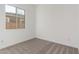 Bright bedroom featuring neutral carpeting and a large window at 24134 N 172Nd Ave, Surprise, AZ 85387