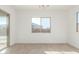Bright bedroom featuring wood-look tile flooring, white walls, and sliding glass door at 24134 N 172Nd Ave, Surprise, AZ 85387