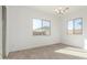 Bright bedroom featuring wood-look tile flooring, white walls, and a modern light fixture at 24134 N 172Nd Ave, Surprise, AZ 85387