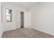 Bright bedroom with neutral carpet, closet, and a window offering natural light at 24134 N 172Nd Ave, Surprise, AZ 85387
