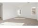 Bright bedroom featuring neutral carpet, white walls, and multiple windows for natural light at 24134 N 172Nd Ave, Surprise, AZ 85387