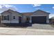 Charming single-Gathering home with gray exterior, paver driveway, well-maintained landscaping, and a welcoming two-car garage at 24134 N 172Nd Ave, Surprise, AZ 85387