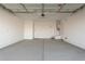 Spacious two-car garage featuring ample lighting and electric garage door at 24134 N 172Nd Ave, Surprise, AZ 85387