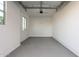 A clean, empty two car garage with gray painted floor and white walls at 24134 N 172Nd Ave, Surprise, AZ 85387