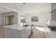 Stylish open-concept kitchen with an island, stainless steel appliances, and tile floors at 24134 N 172Nd Ave, Surprise, AZ 85387