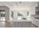 Island with stainless steel sink in a bright kitchen with a large window at 24134 N 172Nd Ave, Surprise, AZ 85387