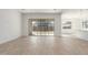 Bright open space with light floors, a sliding glass door, and views into the kitchen at 24134 N 172Nd Ave, Surprise, AZ 85387