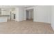 Spacious open-concept living area featuring light-colored tile floors and bright white walls at 24134 N 172Nd Ave, Surprise, AZ 85387