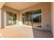 Covered patio with dual sliding glass doors, concrete flooring, and stucco siding at 24134 N 172Nd Ave, Surprise, AZ 85387
