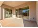 Covered patio with dual sliding glass doors, concrete flooring, and stucco siding at 24134 N 172Nd Ave, Surprise, AZ 85387