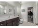 Bathroom features a spacious vanity, a large mirror, and access to a walk-in closet for added convenience at 24408 W Ripple Rd, Buckeye, AZ 85326