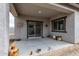 Enjoy this covered patio with textured concrete and decorative wall hangings at 24408 W Ripple Rd, Buckeye, AZ 85326