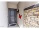 Charming entryway featuring a decorative stone accent wall and a stylish front door at 24408 W Ripple Rd, Buckeye, AZ 85326