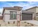 Front elevation of a modern home with a two-car garage, neutral stucco, and tasteful landscaping at 24408 W Ripple Rd, Buckeye, AZ 85326