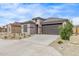 Well-maintained single-Gathering home with stone accents, a two-car garage, and a neatly landscaped front yard at 24408 W Ripple Rd, Buckeye, AZ 85326